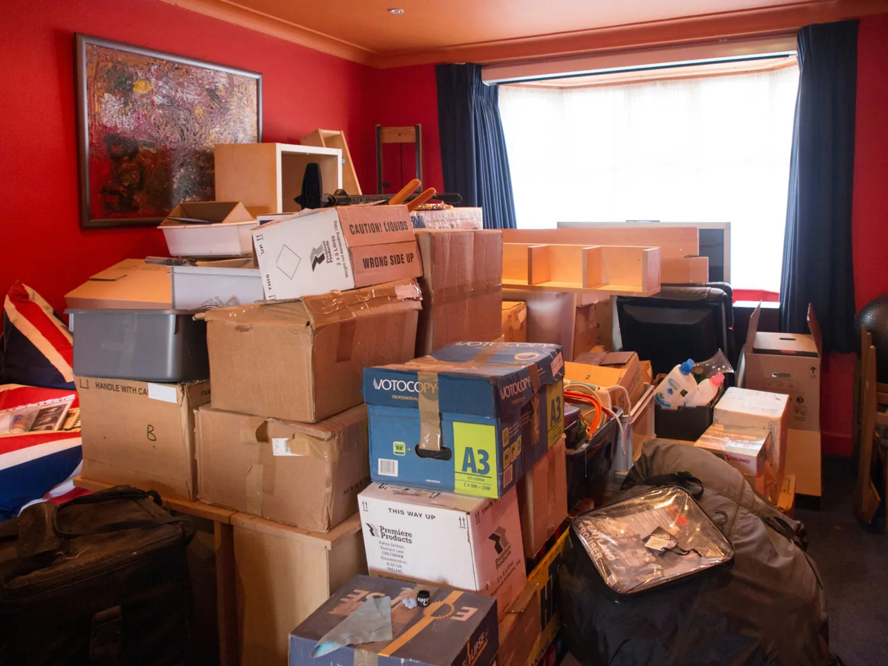 Belongings and boxes filling a living room